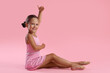 © New Africa - Portrait of little ballerina on pink background