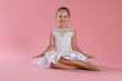 © New Africa - Portrait of little ballerina on pink background