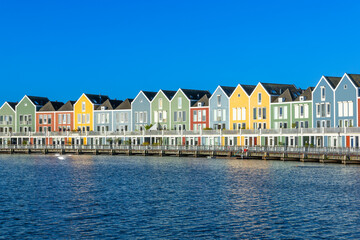 Skyline of Houten with famous Rainbow Houses in the Netherlands. Morning blue sky.