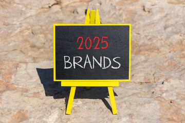 Planning 2025 brands new year symbol. Concept words 2025 Brands on beautiful yellow chalk blackboard. Beautiful stone beach background. Business 2025 brands new year concept. Copy space.