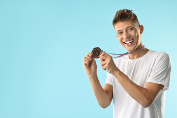 Poster - Happy winner with bronze medal on light blue background. Space for text