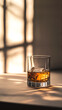 © Justyna - A glass of whiskey with ice on the table