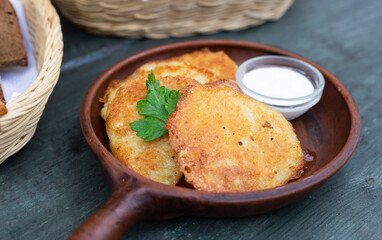 Fried grated potato pancakes with sour cream