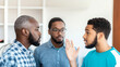 © Unreally Studio - Group of black guys having a animated talk inside a house