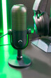 © oselote - Curved microphone and gaming headphones in neon green lighting