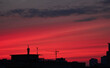 © Ryzhkov Oleksandr - Crane and Buildings Silhouetted Against a Vibrant Sunset