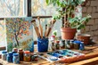 © Ilia - A bright art studio featuring a vibrant tree painting, surrounded by brushes, paint jars, and a potted plant by a sunlit window. ideal for themes of creativity and inspiration.