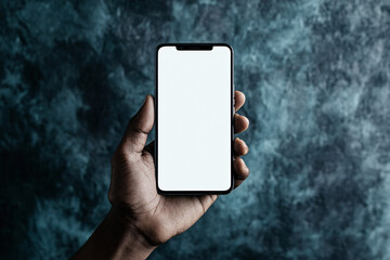 A hand holds a smartphone with a blank white screen against a textured background ready for input or customization highlighting technology
