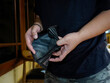 © Harris Kharisma - close up of a man's hand holding and his empty wallet without a penny