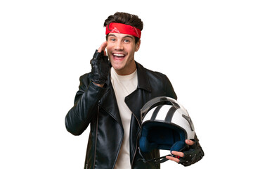 Wall Mural - Young caucasian man with a motorcycle helmet over isolated background shouting with mouth wide open