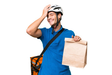 Wall Mural - Young caucasian man taking a bag of takeaway food over isolated background smiling a lot