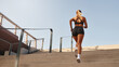 © Valerii Apetroaiei - An Athletic Woman Engaging in Climbing Stairs as Part of Her Fitness and Health Routine