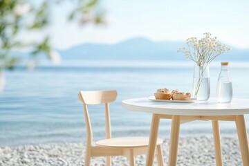 serene seaside setup featuring a small round white table with two wooden chairs, placed right at the edge of the water on a pebbled beach