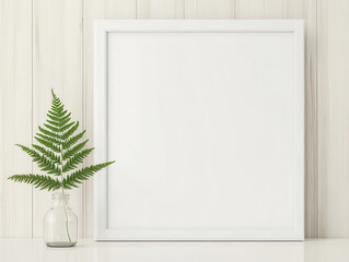 Wall Mural - minimalist interior scene featuring blank white frame and green fern in glass vase, creating serene and fresh atmosphere. Perfect for showcasing art or photography