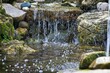 © dslr-user61 - Serene Waterfall Flowing Over Rocks
