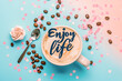 © Elena - Motivation phrase Enjoy Life on light blue background with a cup of coffee