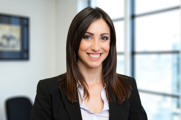 Happy businesswoman smiling in modern office