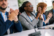 © Mediteraneo - Group of multiracial business people applauding on a business meeting.