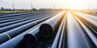 © dinastya - PE pipe plant, Industrial PE pipes pile for gas and water. HDPE Polyethylene PE100 pipe, background with copy space.