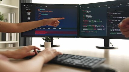 Slow motion back end software developer engineer for computer programming working together on debugging writing computing code, solving complex algorithms display on monitor in office. Burgeoning