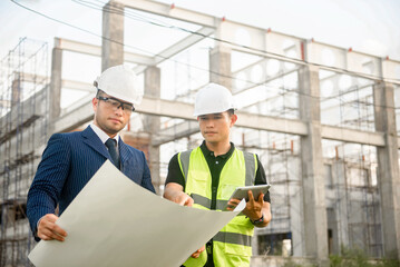 Engineer and architect monitor the progress of building construction plan and verify their accuracy.