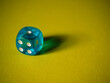 © klevo - Blue dice on yellow paper background. Cardboard bright background with texture. Concept of luck, testing fate, lottery, decision making. Place for text. Copy space. Rovinj, Croatia - October 4, 2024