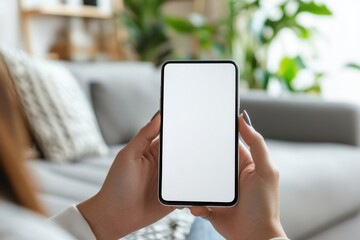 close-up of a woman's hand holding a smartphone with a blank white screen