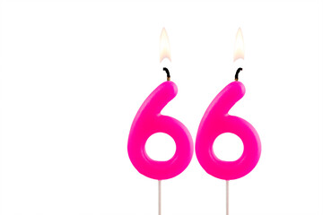 Pink number 66 birthday candle on white background