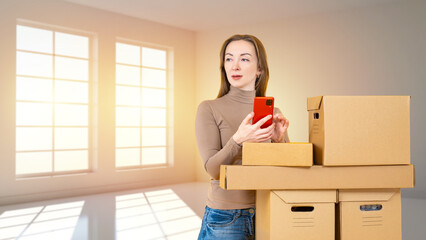 Woman with phone is engaged in moving. Girl with boxes stands in empty room. Business woman moving to new office. Relocation and change of real estate. Girl moving to improve living conditions