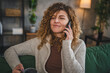 © Miljan Živković - woman with curly hair at home use mobile phone smartphone have a call