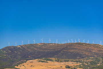 Many wind turbines on the mountain. Windmills installed on the mountain generate electricity. Renewable energy sources