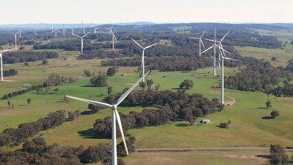 Wall Mural - aerial drone pullback reverse view of an array of large wind turbines at biala and gullen range wind