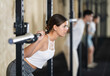 © JackF - Young woman in sportswear training with barbell in gym