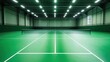 © aubriella - A vibrant indoor badminton court with green flooring, white boundary lines, and overhead lighting