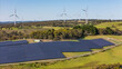 © Steve - Aerial drone view of a hybrid solar and wind farm showing the large wind turbines in the background for renewable clean energy supply located at Bannister, NSW, Australia on a sunny day