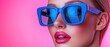 © Watercolor_Kawaii - Chic woman wearing oversized blue sunglasses against a vibrant pink background. Modern fashion statement.
