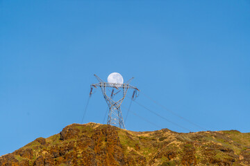 Wall Mural - 500kV transmission towers and full moon in the Andes mountain range