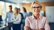 © PulseImages - Confident Blonde Businesswoman Smiling in a Professional Setting