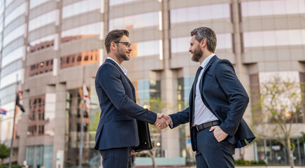 Wall Mural - Two businessmen partner celebrating business deal. Successful partnership in business deal. Businessmen dealing outdoor. Partnership success. Celebrate business partnership. Banner