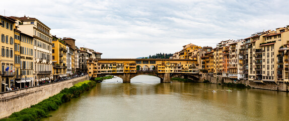 Ponte Vecchio, old bridge on the river in Florence with dramatic sky