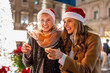© Lomb - Joyful women celebrating Christmas with sparklers at festive market, holiday cheer and friendship