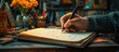 © GoDress - A person's hand writing in a journal with a pen.