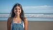 © Rufino - A young woman is smiling and standing on a beach