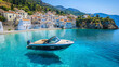 © Matthias - Motorboat Floating in Crystal Clear Water with Greek White Buildings in the Background