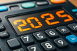 © Pixel World Vision  - A close-up view of a calculator displaying the number 2025 during a calculation session in a bright office setting