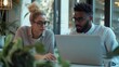 © kitipol - High-resolution photorealistic capture of two diverse colleagues brainstorming ideas in a sleek, minimalist co-working space The focus on the laptop and their positive interaction is enhanced by 32k