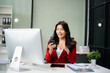 © laddawan - Young Asian businesswoman working with working notepad, tablet and laptop documents talking on the smartphone, tablet