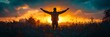 © inspiretta - A man is standing in a field with his arms raised in the air, looking up at the sun. The scene is serene and peaceful, with the sun setting in the background