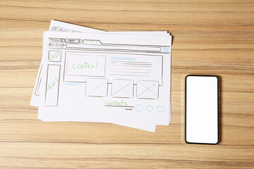 Wall Mural - website development. sketches of wireframes and smartphone on wooden table, flat lay