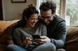 © ChaoticMind - A lovely couple, nestled together on a couch, shares laughs while engaging with a smartphone, exuding warmth and connection in a sunlit, inviting room.